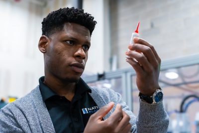 Engineer holding a syringe after using process validation to achieve quality results