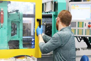 Plastic Engineer Working with Plastic Injection Molding Machine