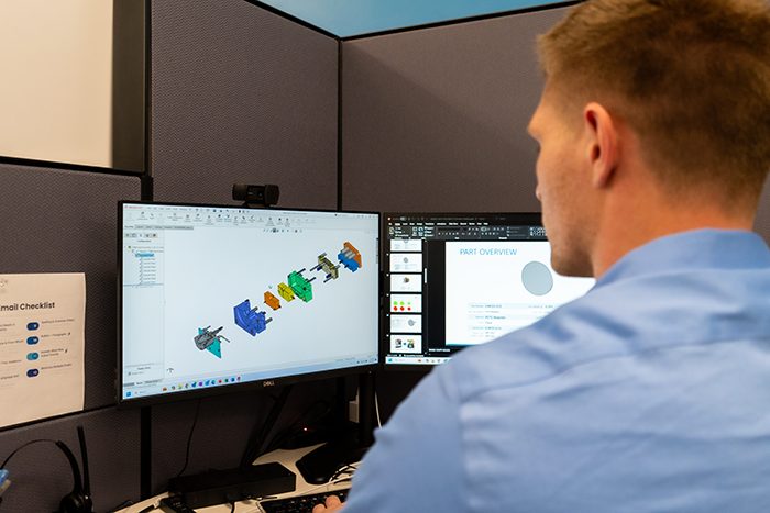 Engineer looking at CAD files for injection mold to understand mold design