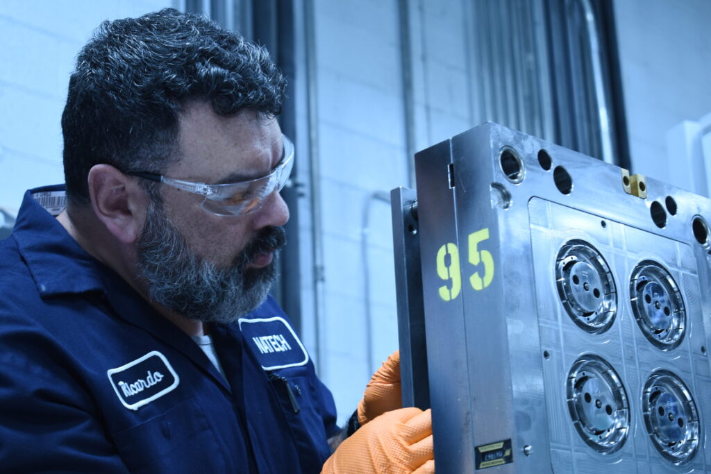 Close-up of an injection mold cavity surface being reviewed during mold transfer evaluation