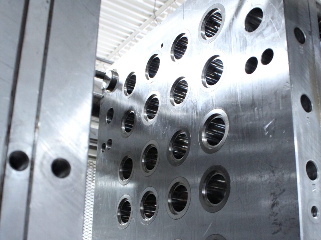 Large multi-cavity mold plate prepared for controlled processing and production setup